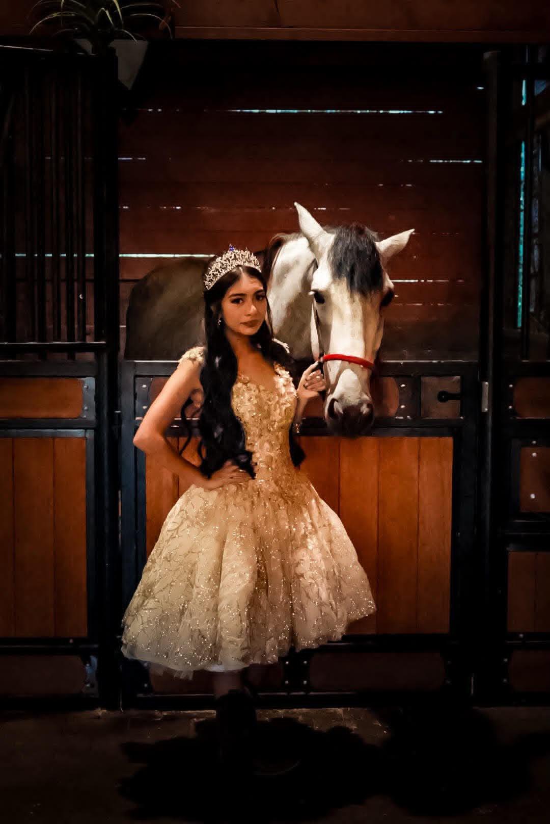 Giuliana wearing her quinceañera dress beside a white horse